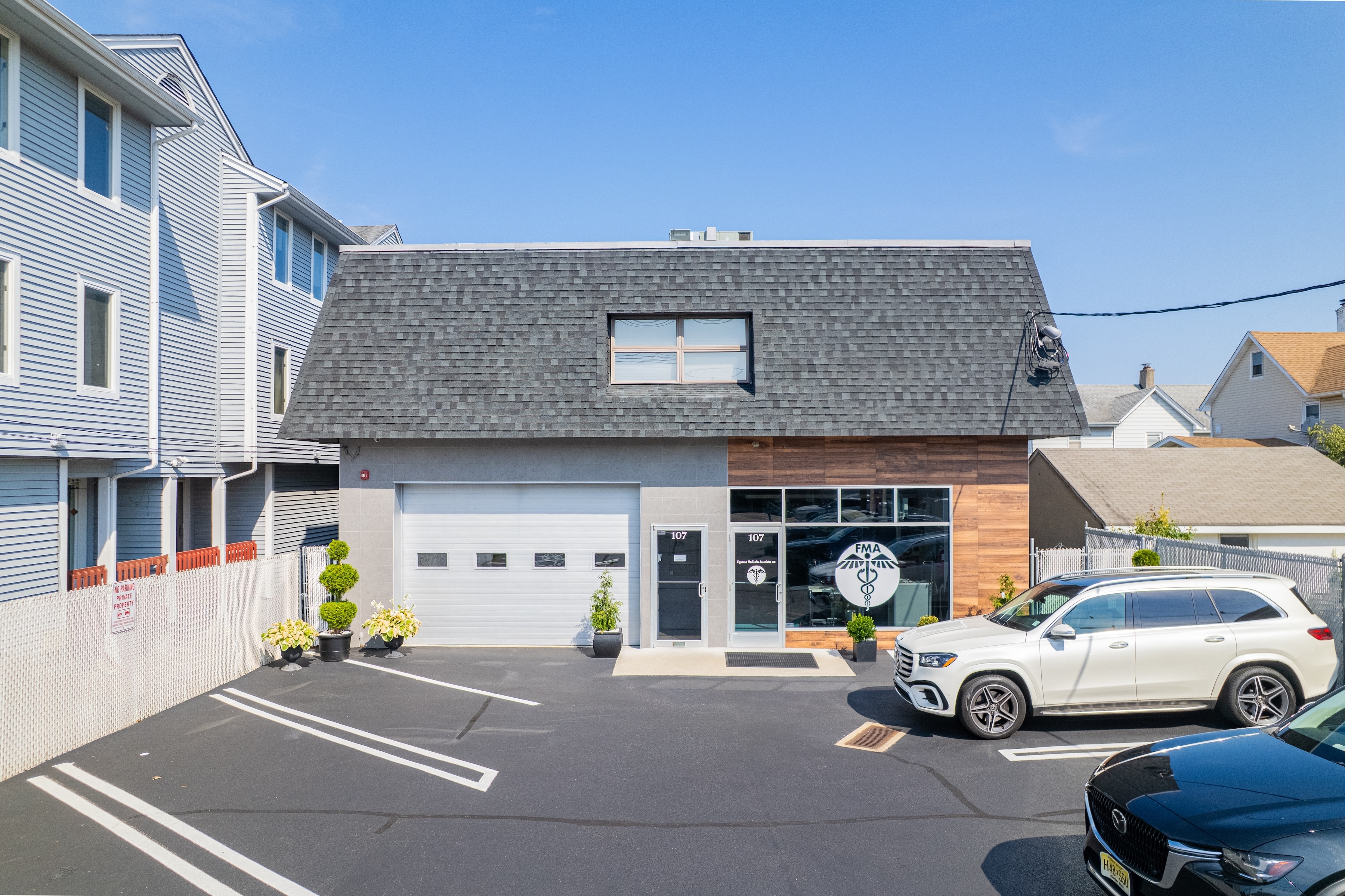 Front exterior and parking area at 107 Stuyvesant Ave