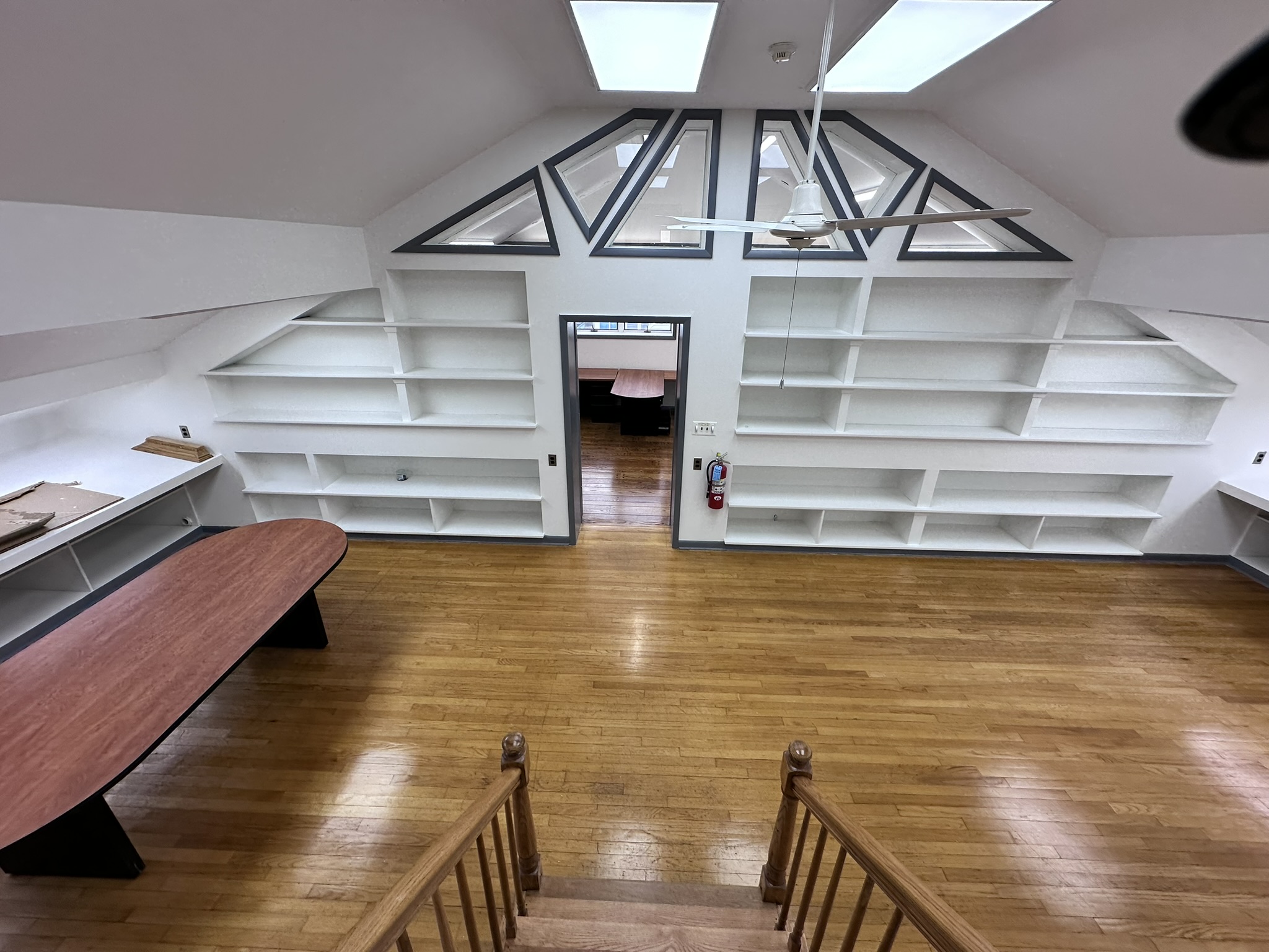 Suite 201 loft-style office area with built-in shelving